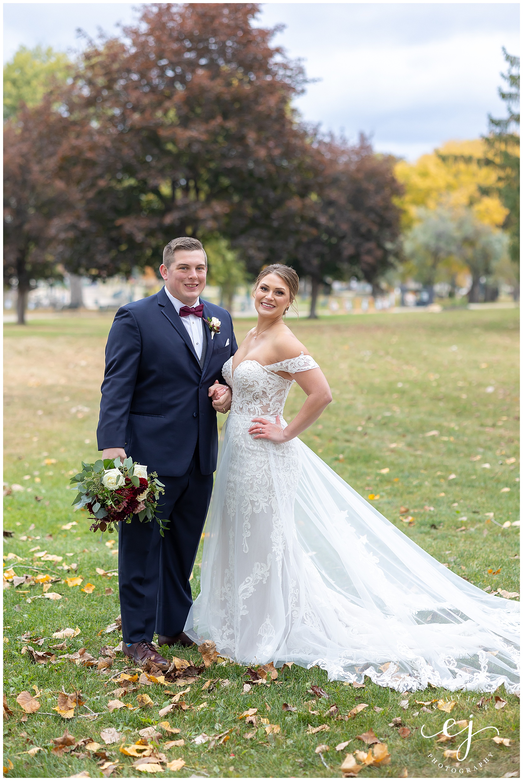 bride and groom posing in riverside park autumn wedding