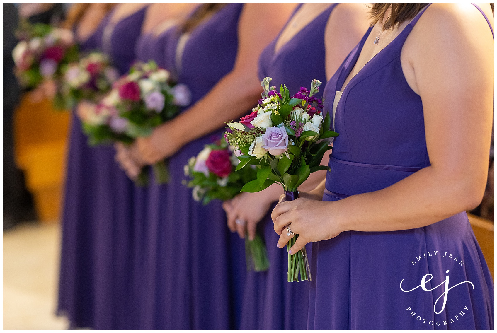 bridesmaids holding flowers during wedding ceremony
