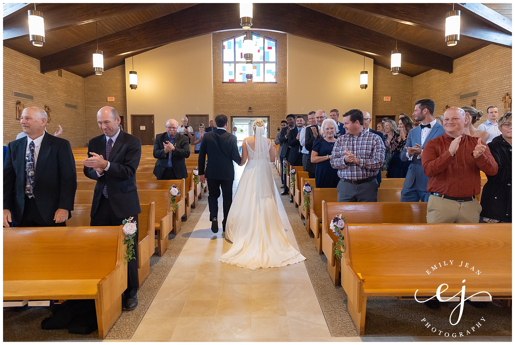 bride and groom exiting recessional catholic church wedding