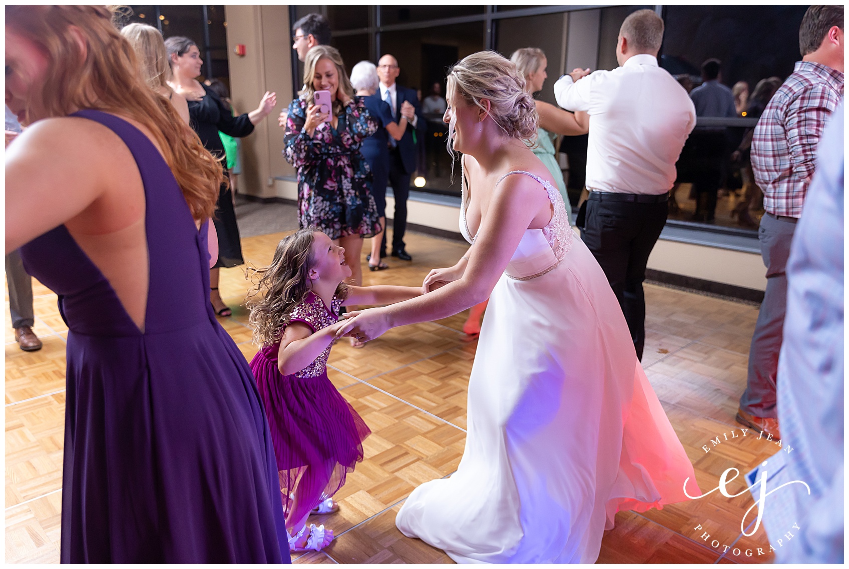 bride and little girl smiling on dance floor