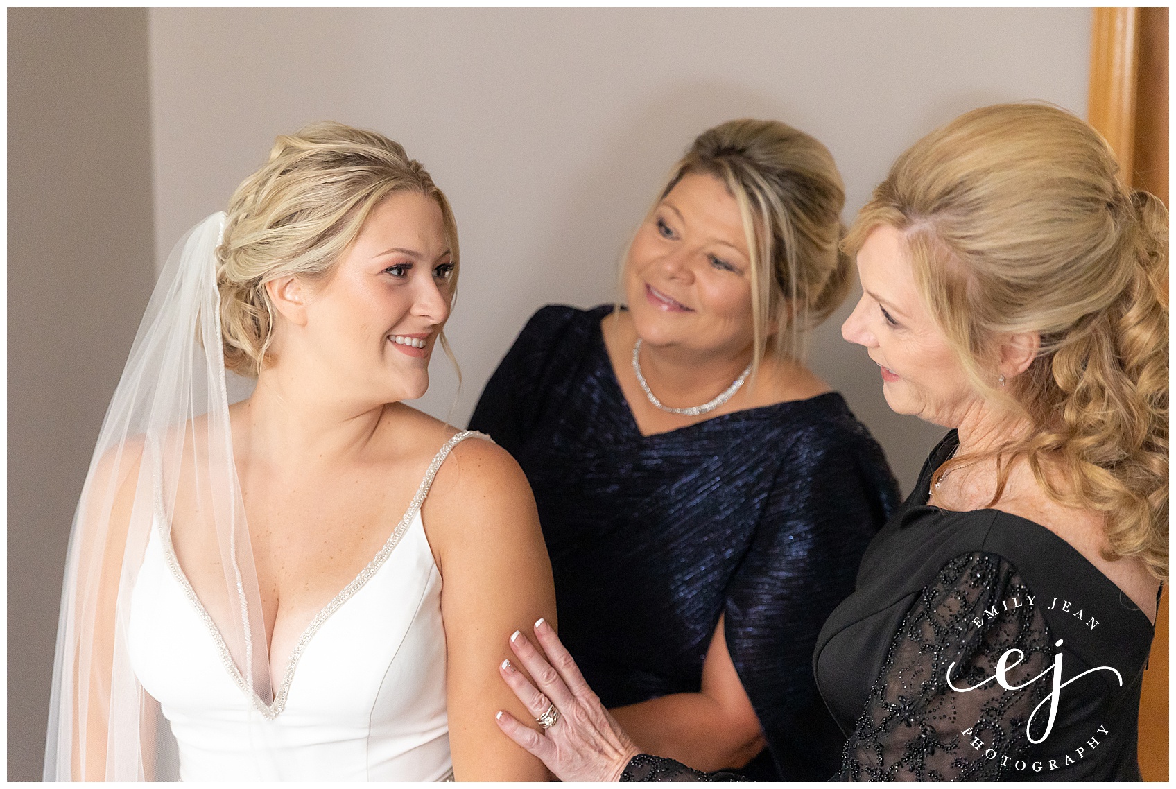 bride getting ready with mom and step mom