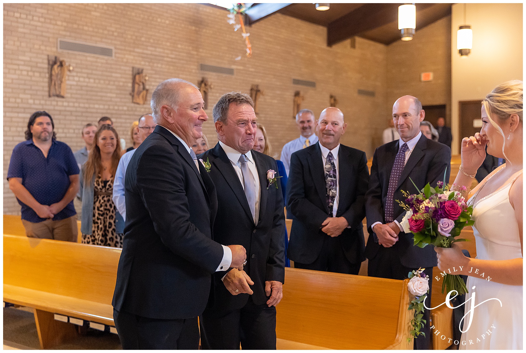 step dad and dad shaking hands walking bride up the aisle