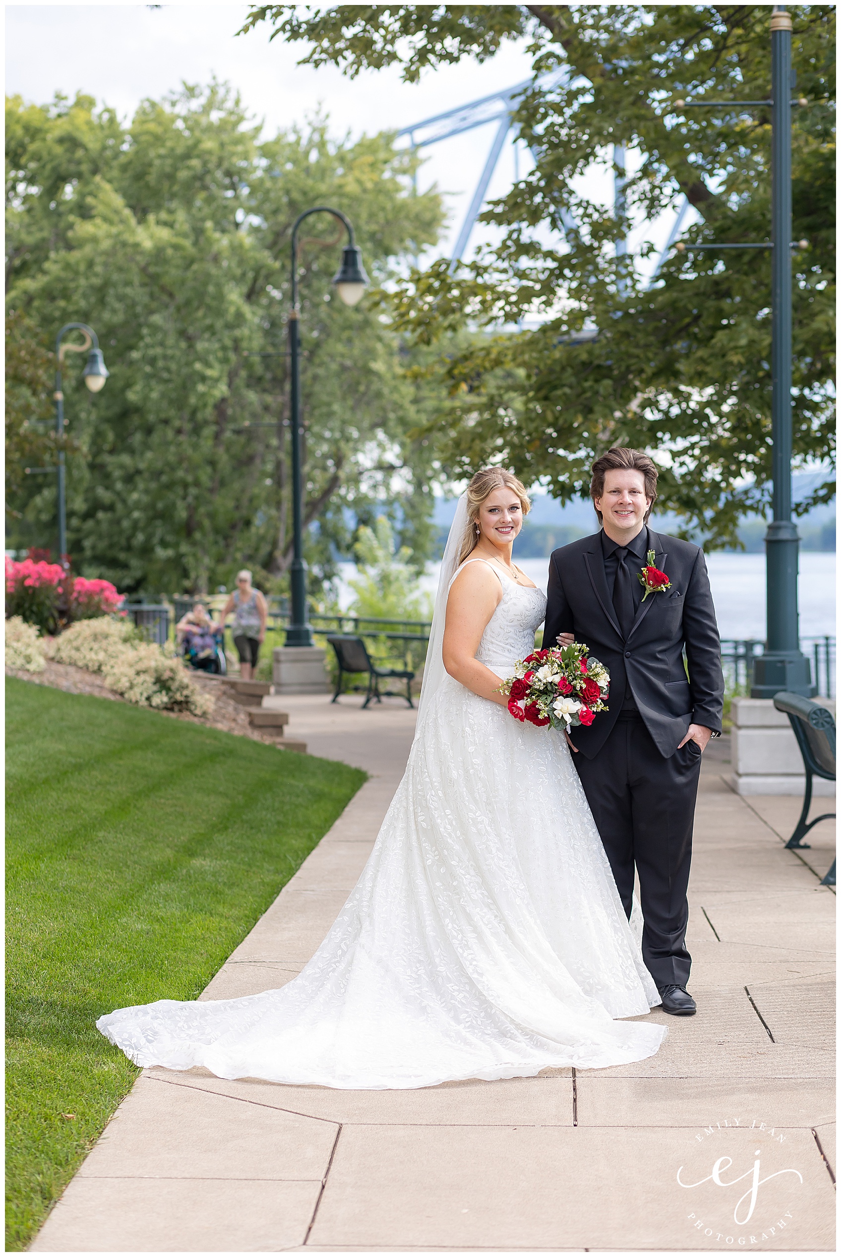 Walking near Mississippi River at the waterfront bride and groom classic portrait