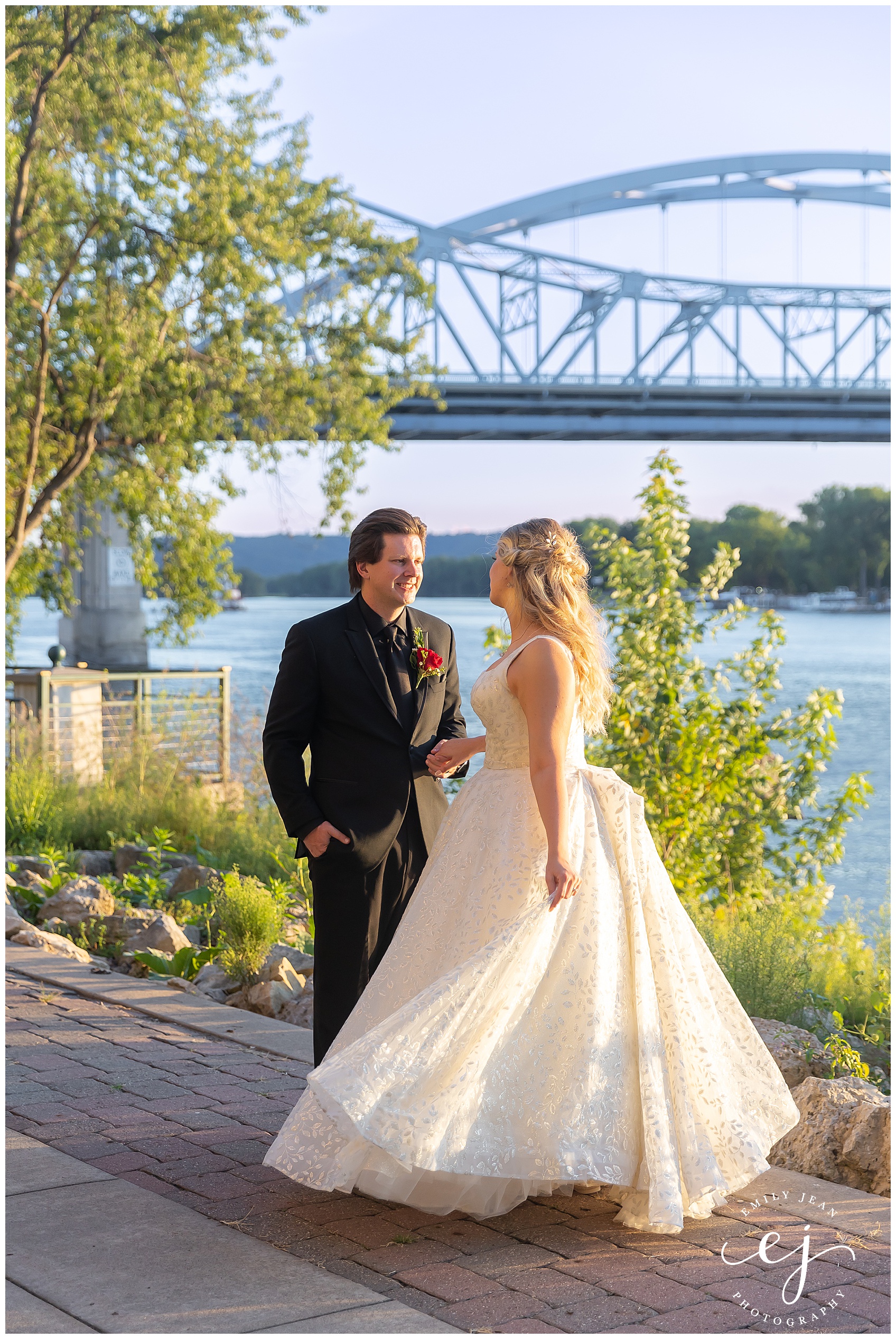 Bride and groom outside in the sunset near the big blue bridge