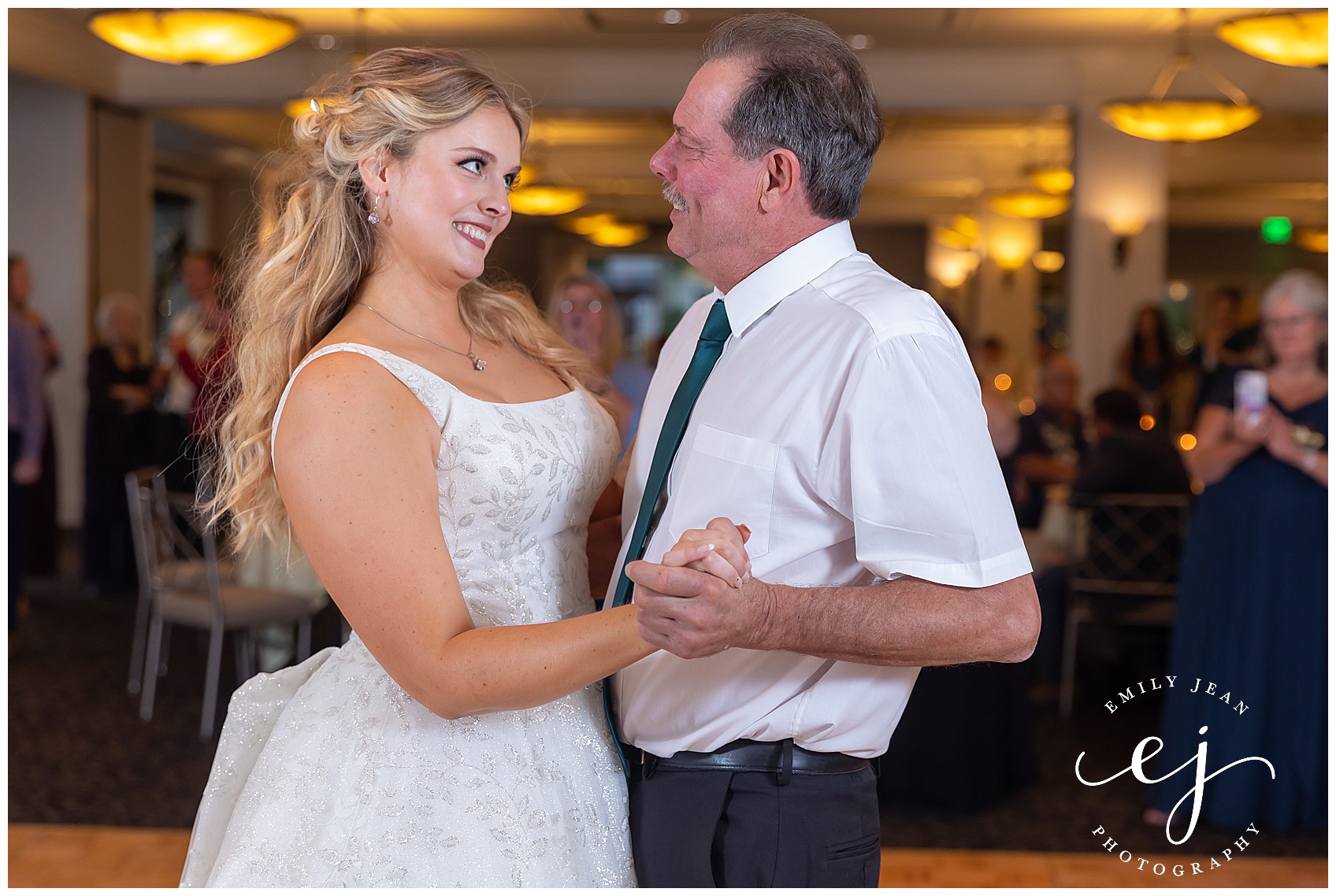 Bride and her, smiling and crying during father daughter dance