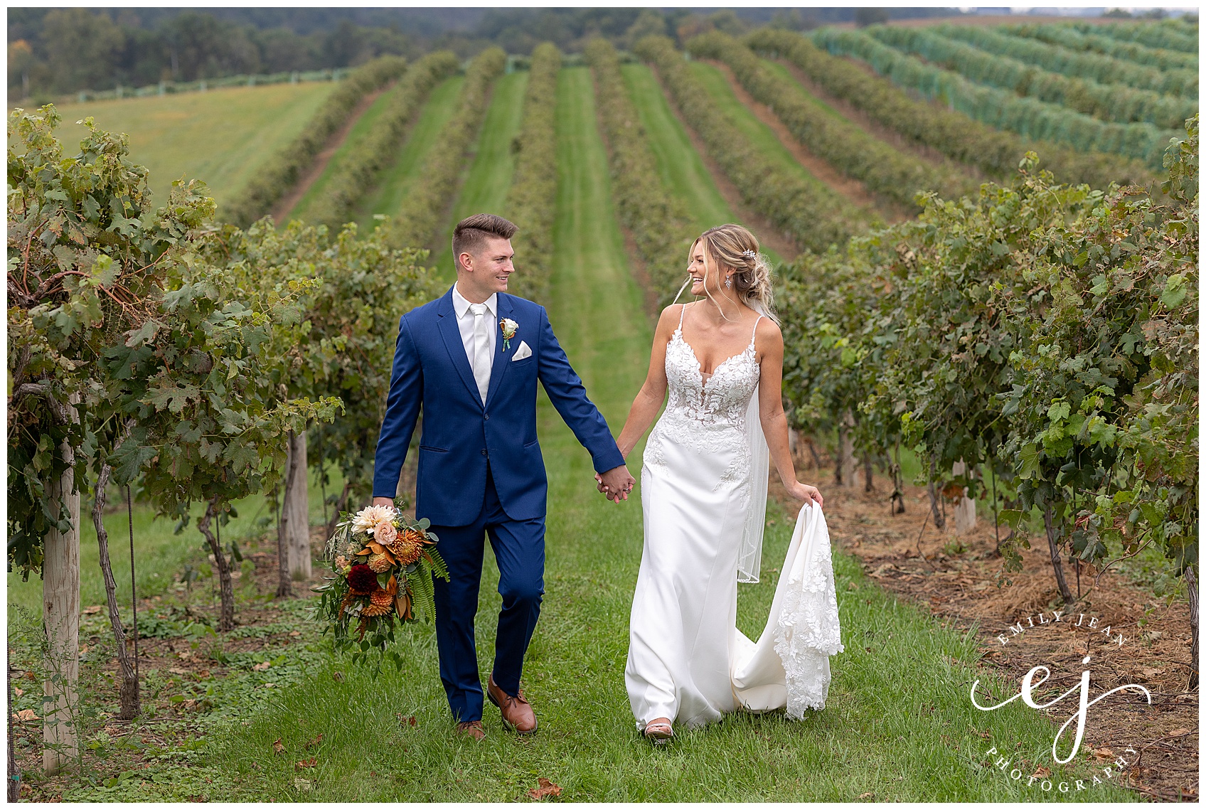 bride and groom walking through the vineyard on their wedding day
