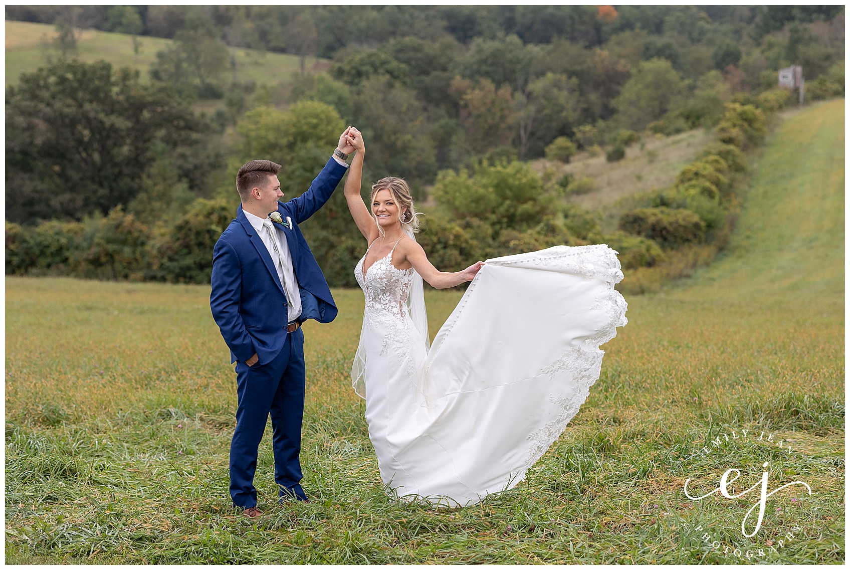 bride and groom twirling in the open field