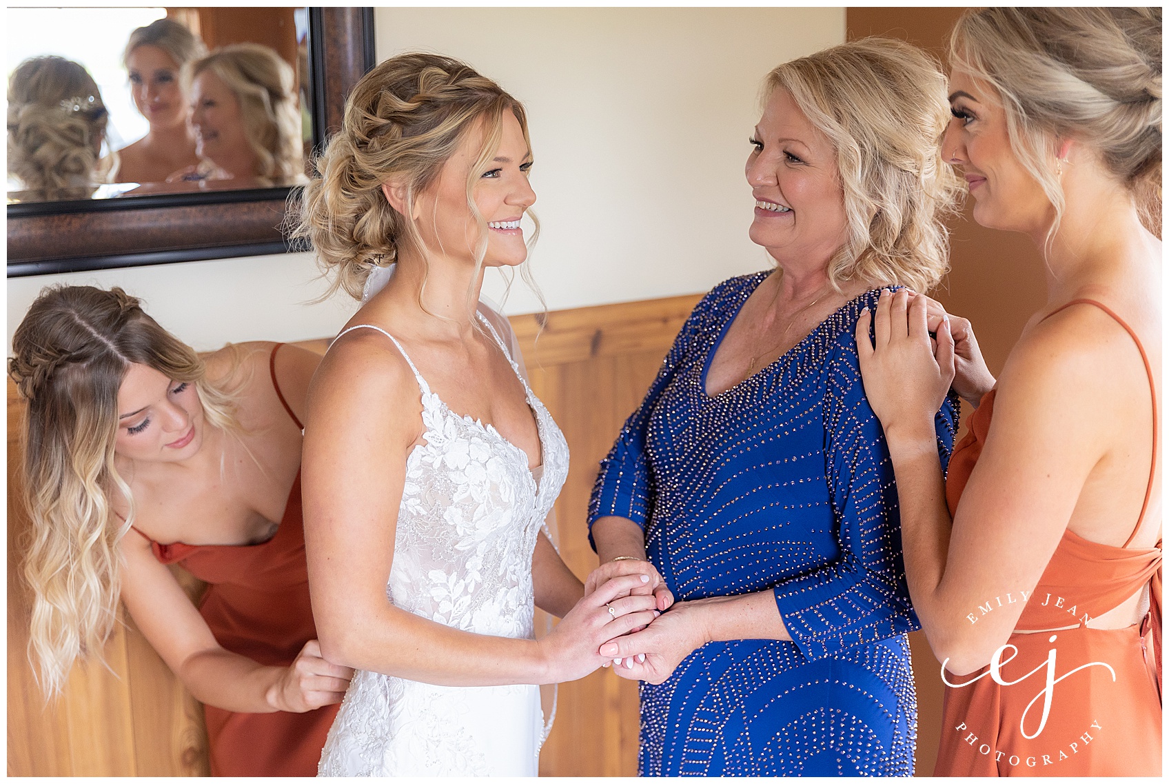 maid of honor and mom helping bride get dressed emotional and joyful