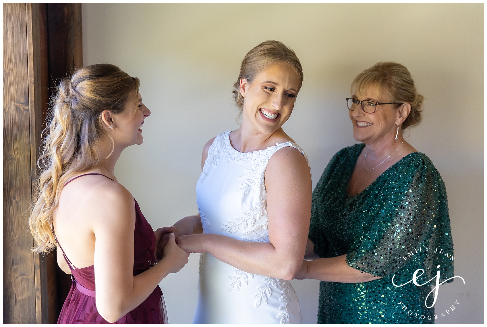 maid of honor and mother helping the bride get dressed