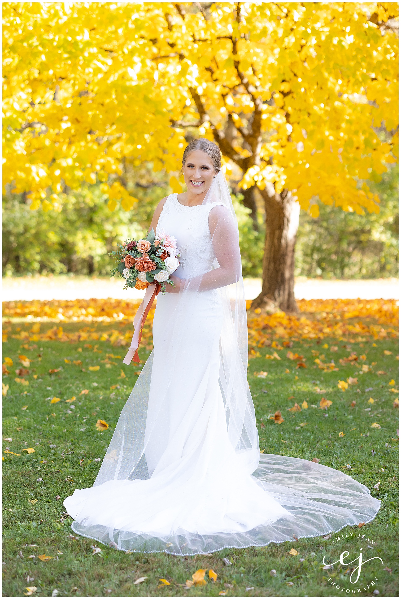 tall blonde bride with sleek bun and long veil