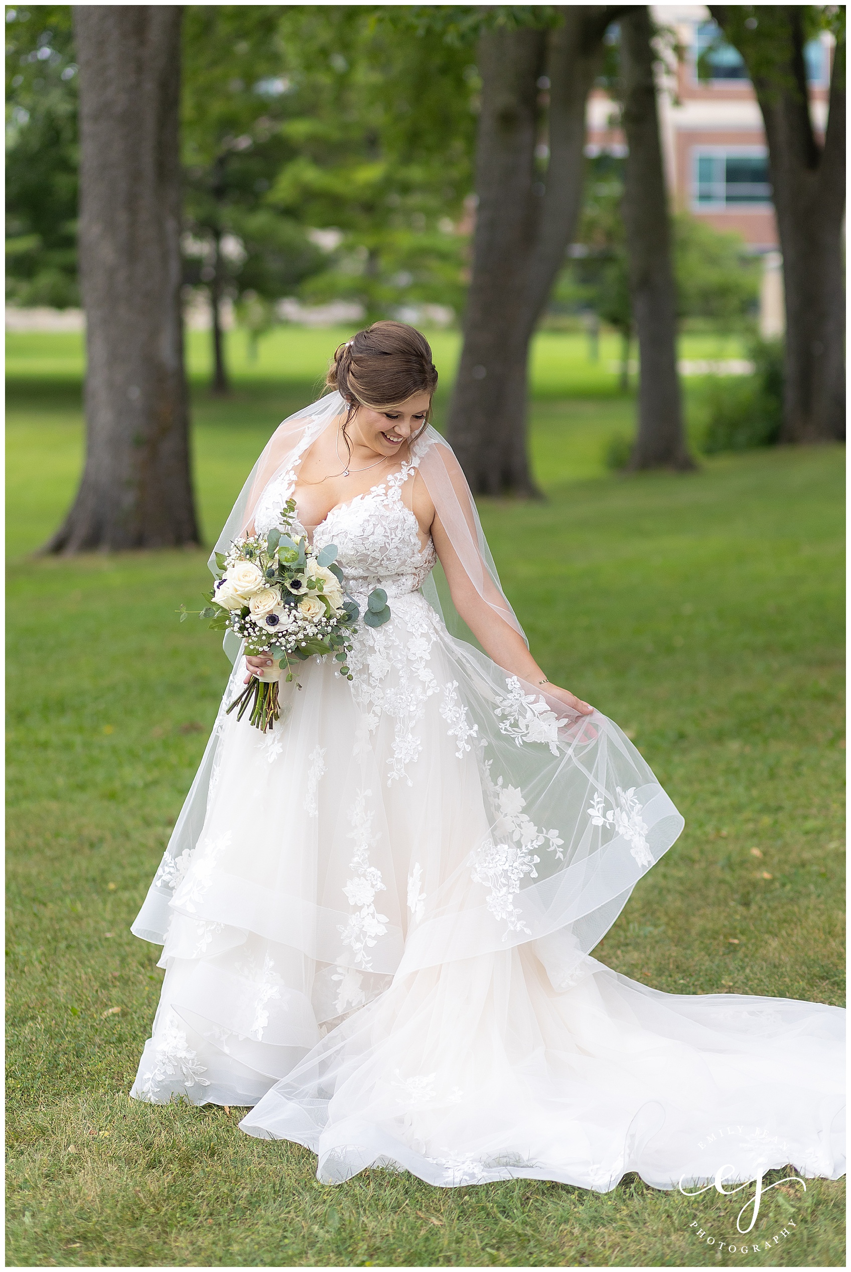 bride wearing lace dress with horsehair white and green flowers
