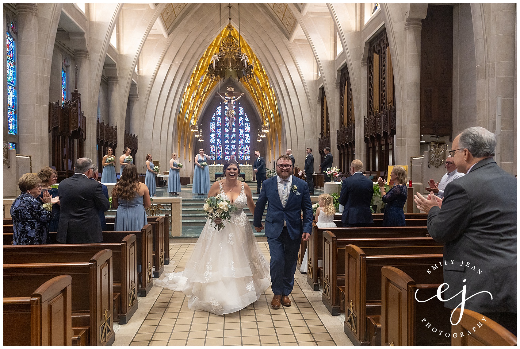 recessional bride and groom smiling walking down aisle at the cathedral