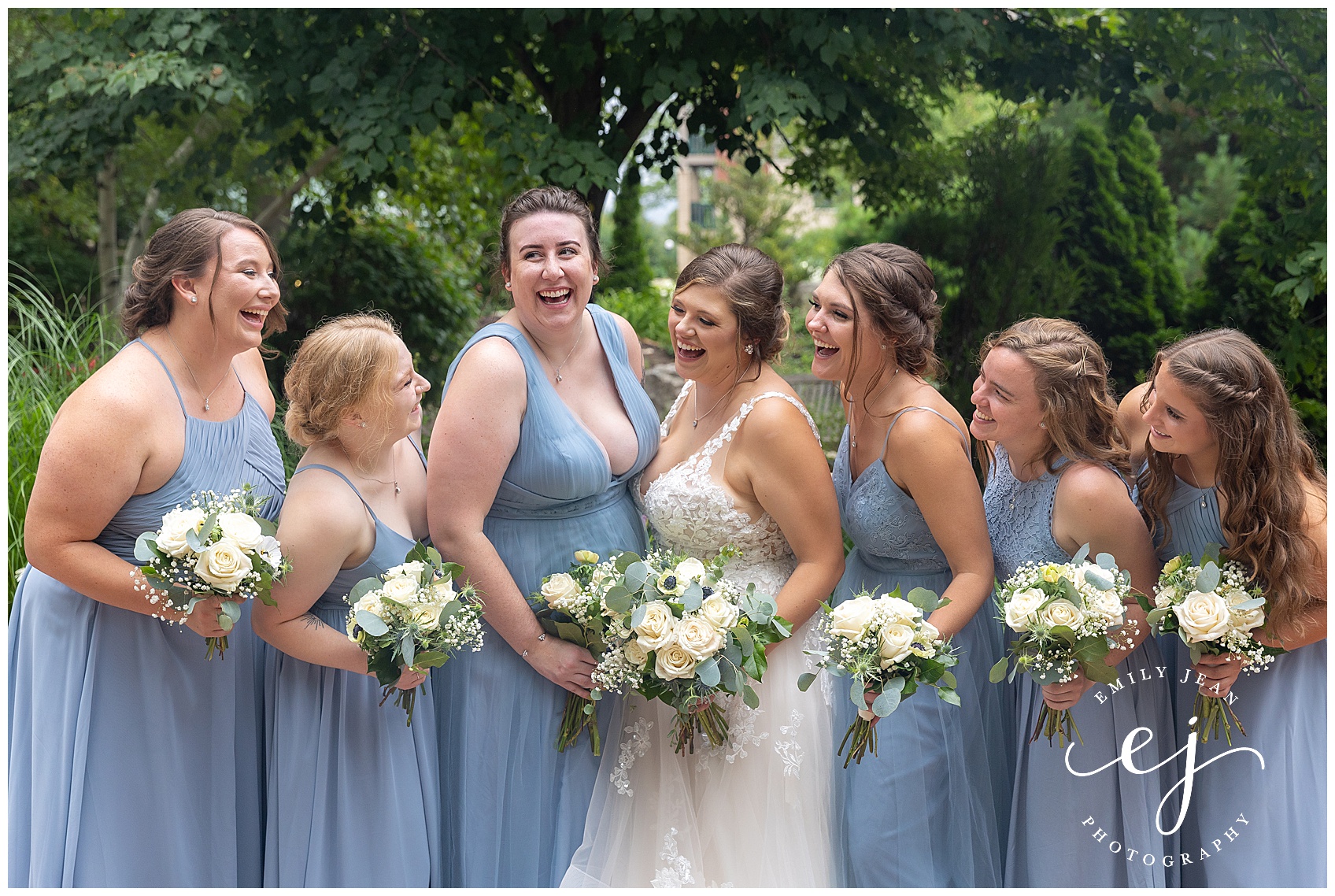 bride and bridesmaids smiling and laughing looking at each other