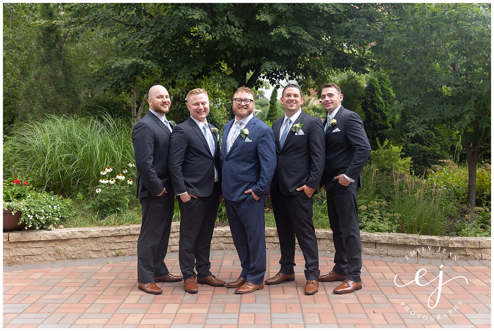 groomsmen wearing navy and dark grey standing