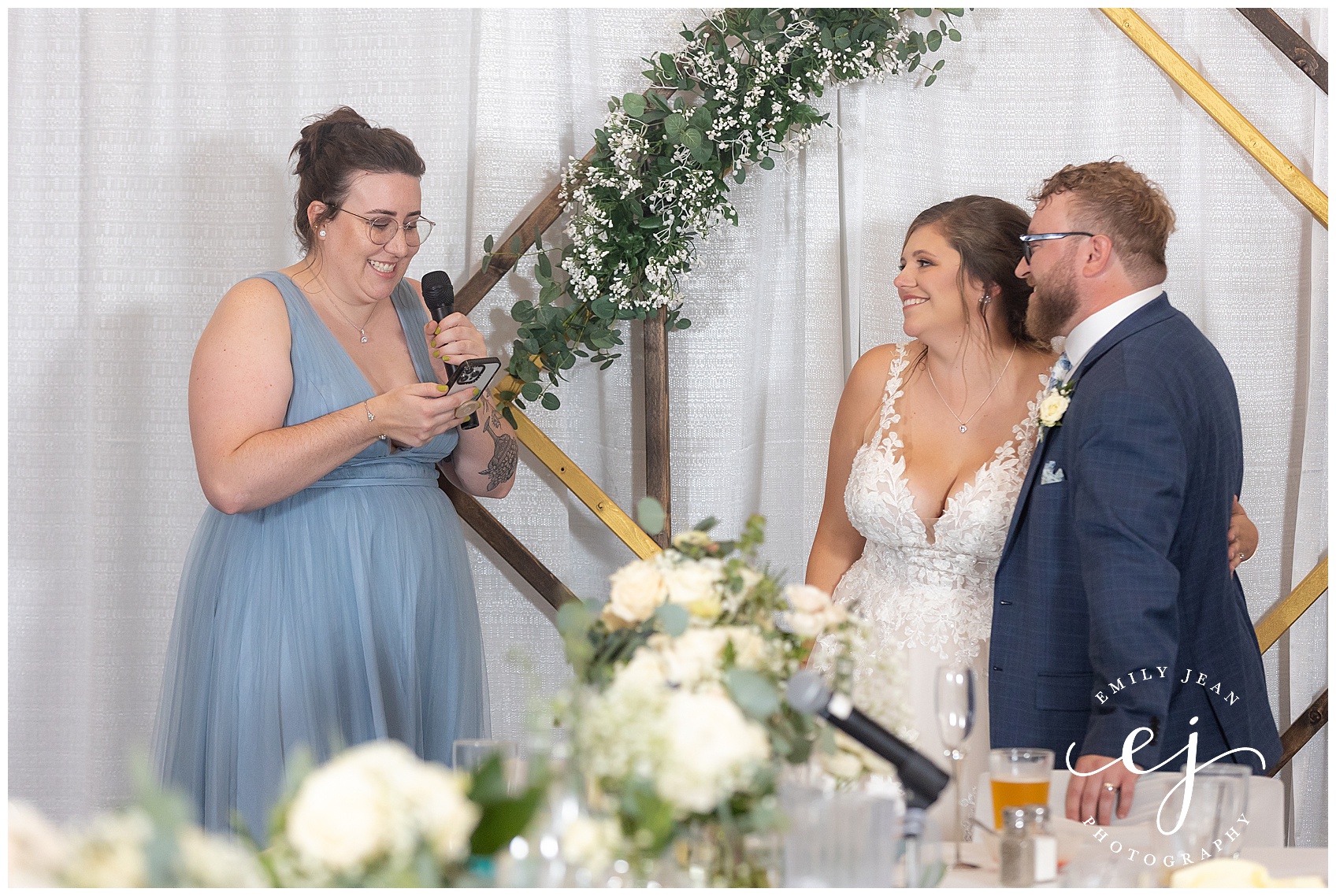 maid of honor speech with bride and groom smiling and laughing