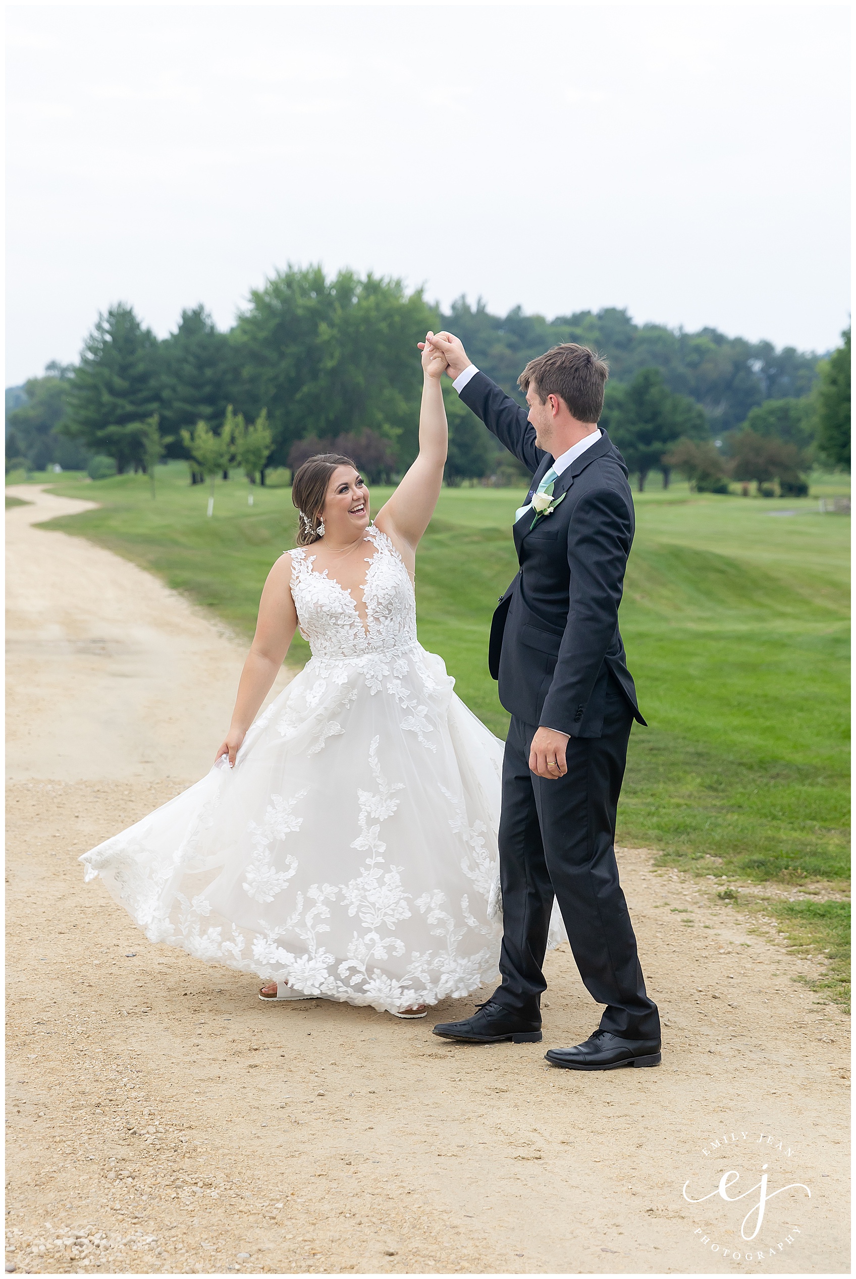 bride twirling on gravel path at fox hollow golf course