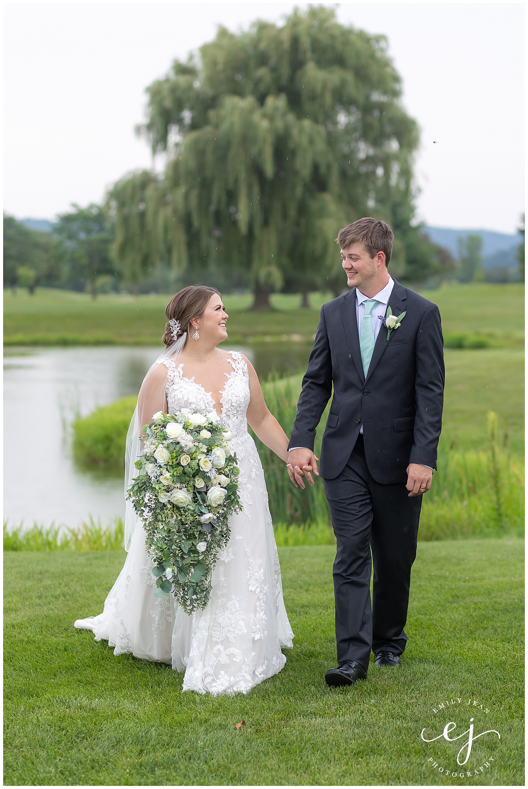 bride and groom walking along water at fox hollow golf course west salem wisconsin