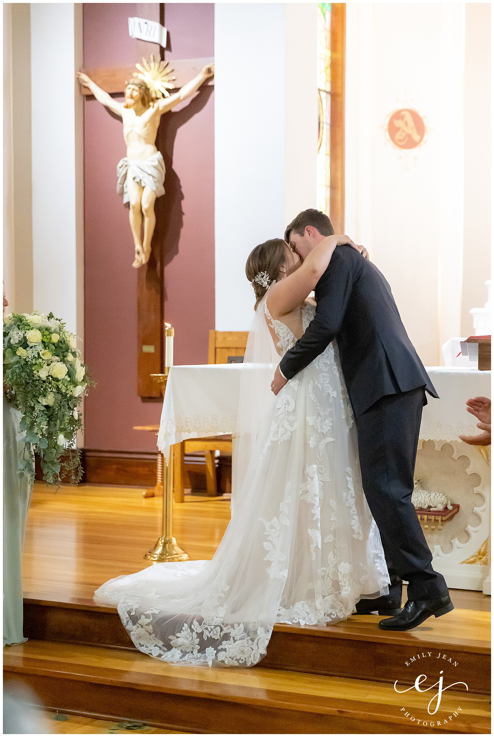 bride and groom first kiss ceremony catholic church service