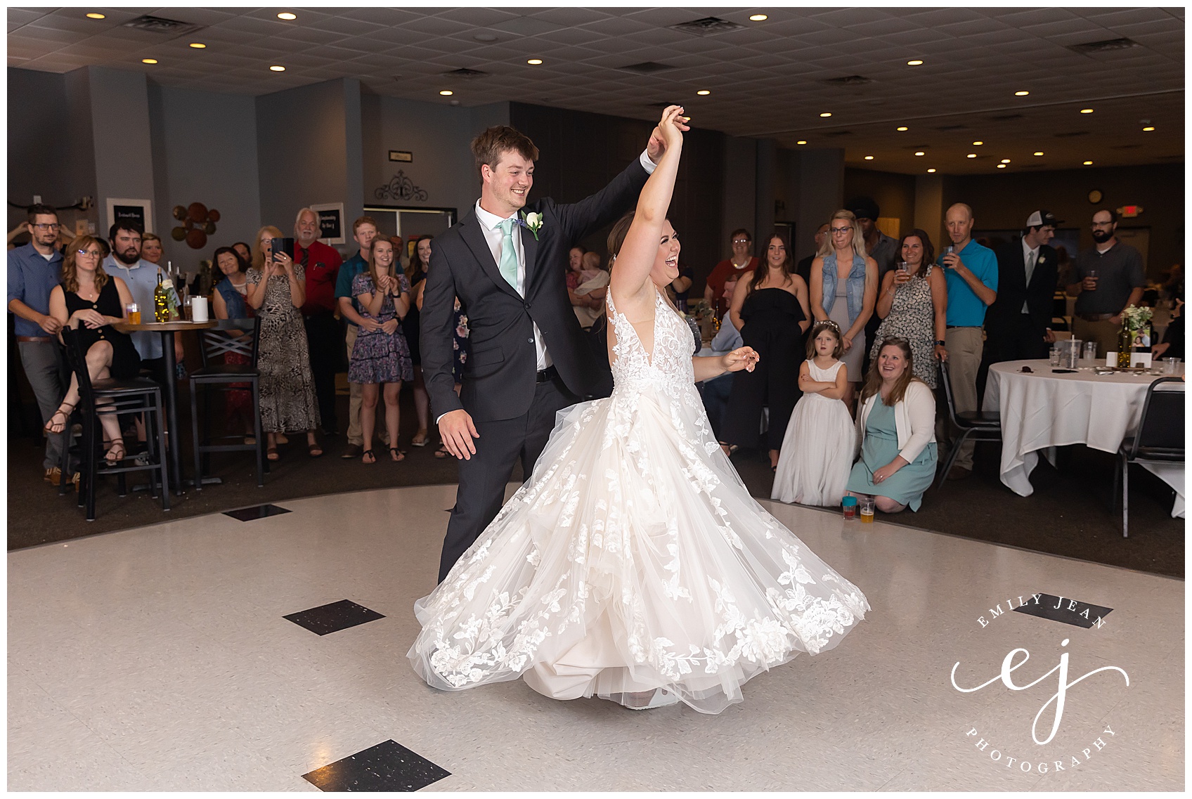 groom twirling bride during first dance at fox hollow golf course