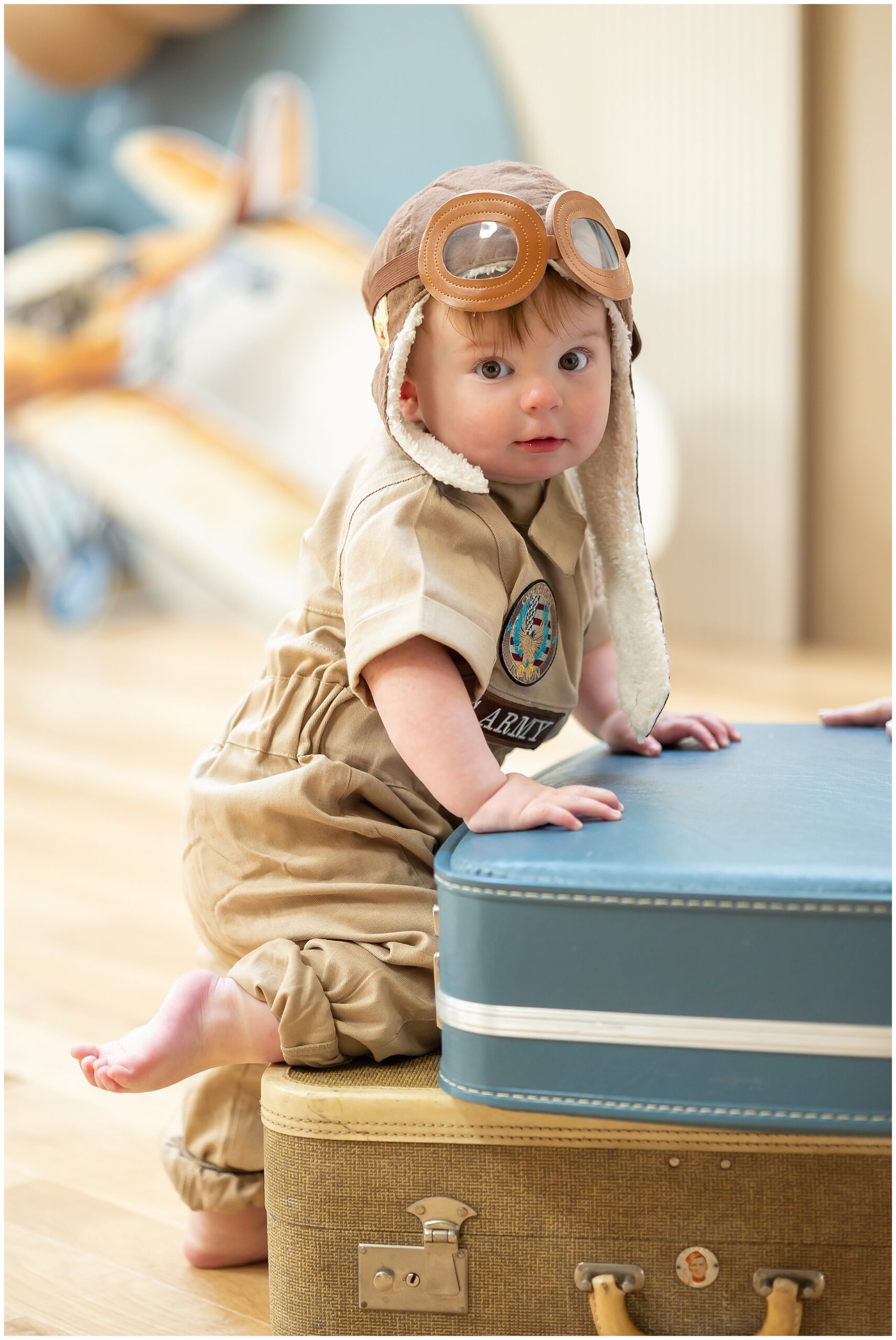 Candid of Theodore smiling in front of a vintage suitcase display