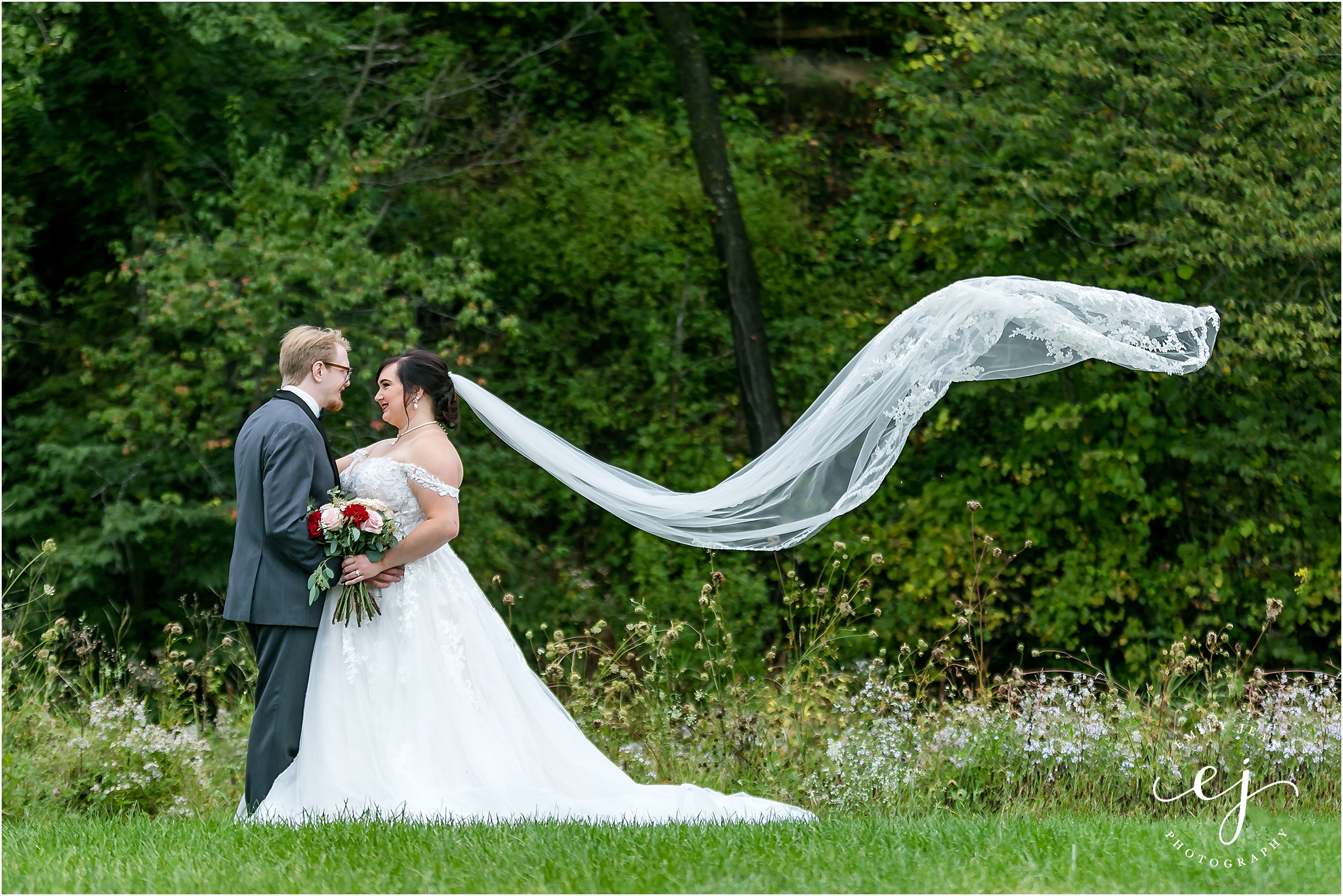 bride and groom long veil blowing in wind at winnebago springs wedding venue in caledonia minnesota