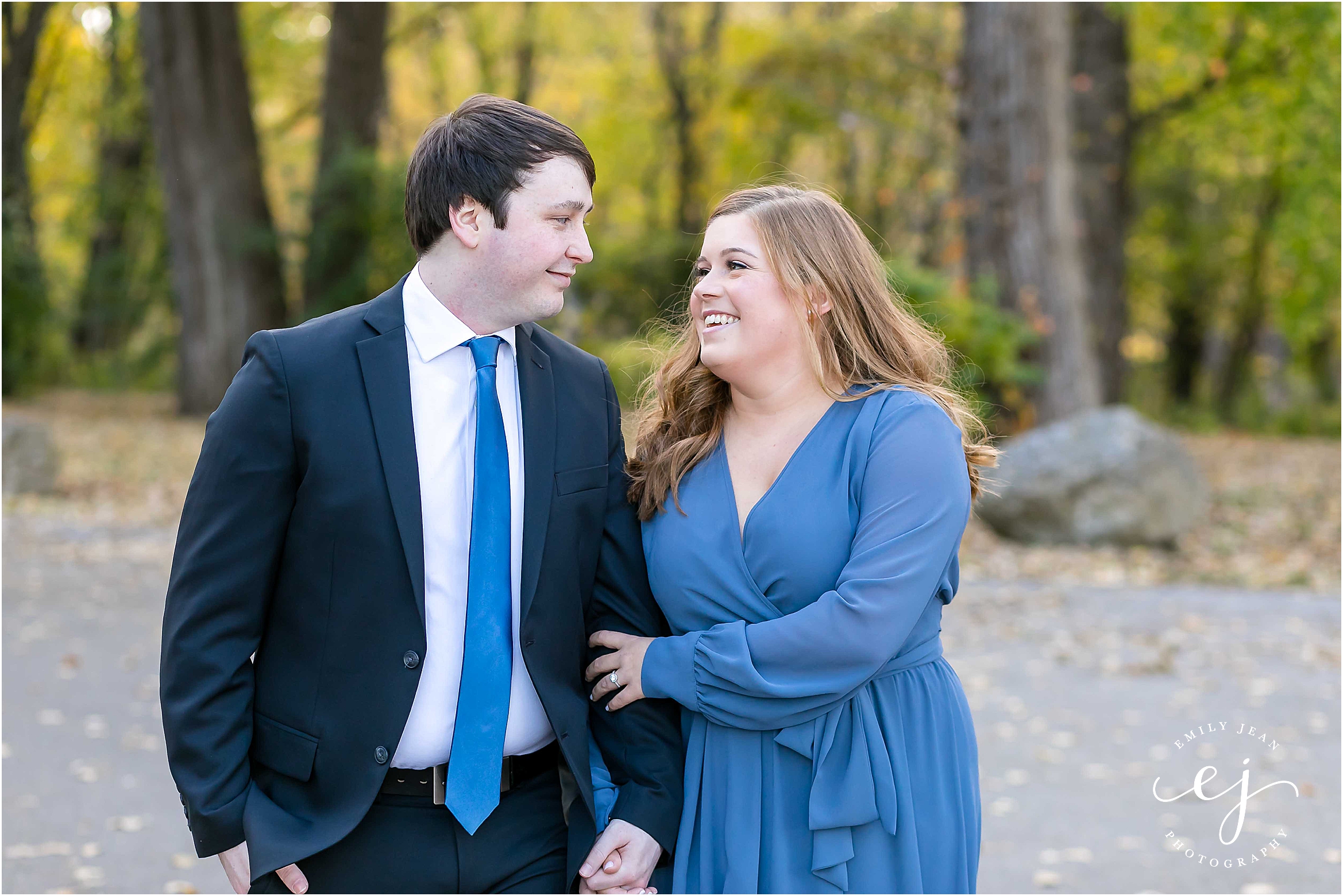 engagement session suit and tie long blue dress walking in park