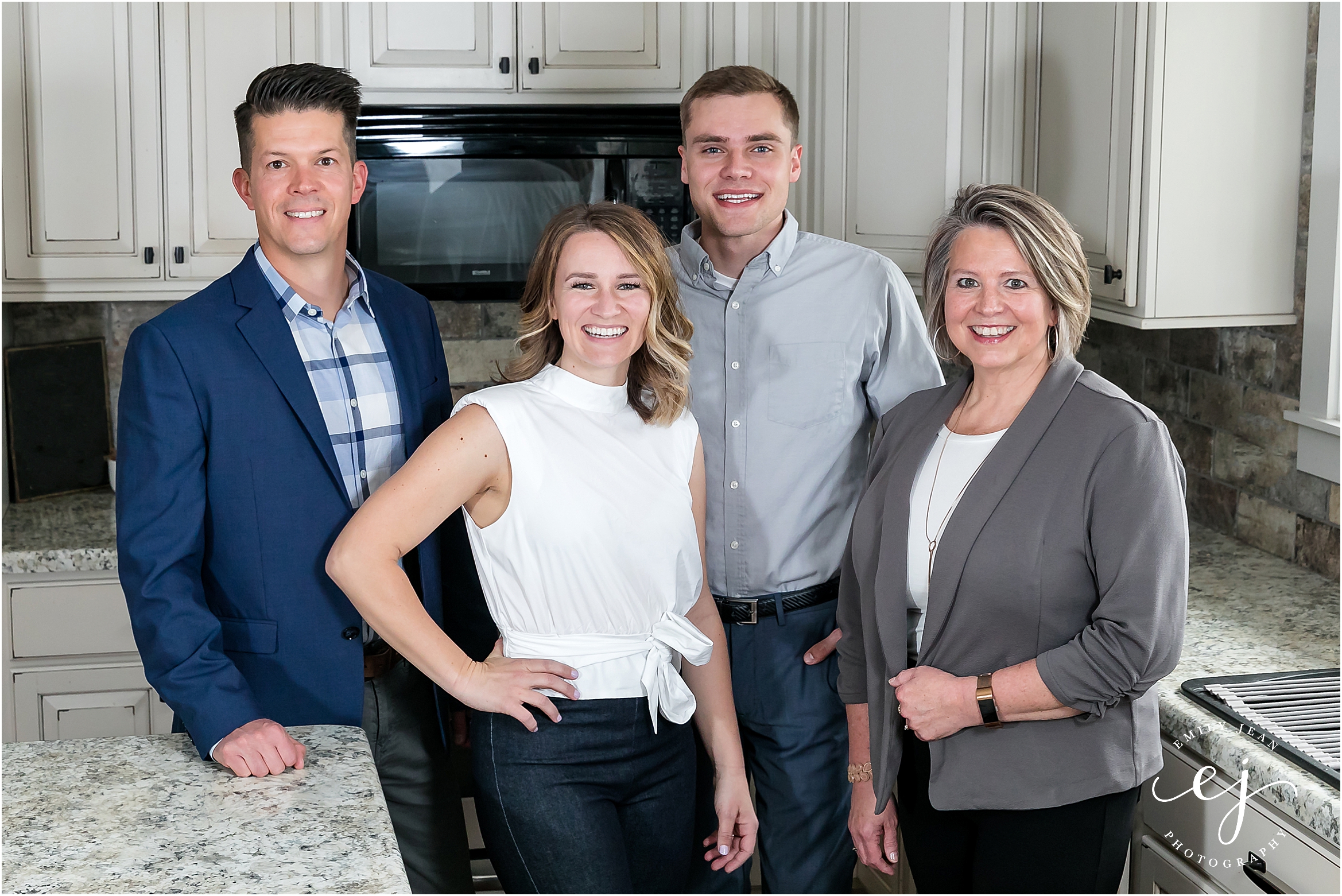 Top real estate agent lacrosse Wisconsin team standing in kitchen one trust