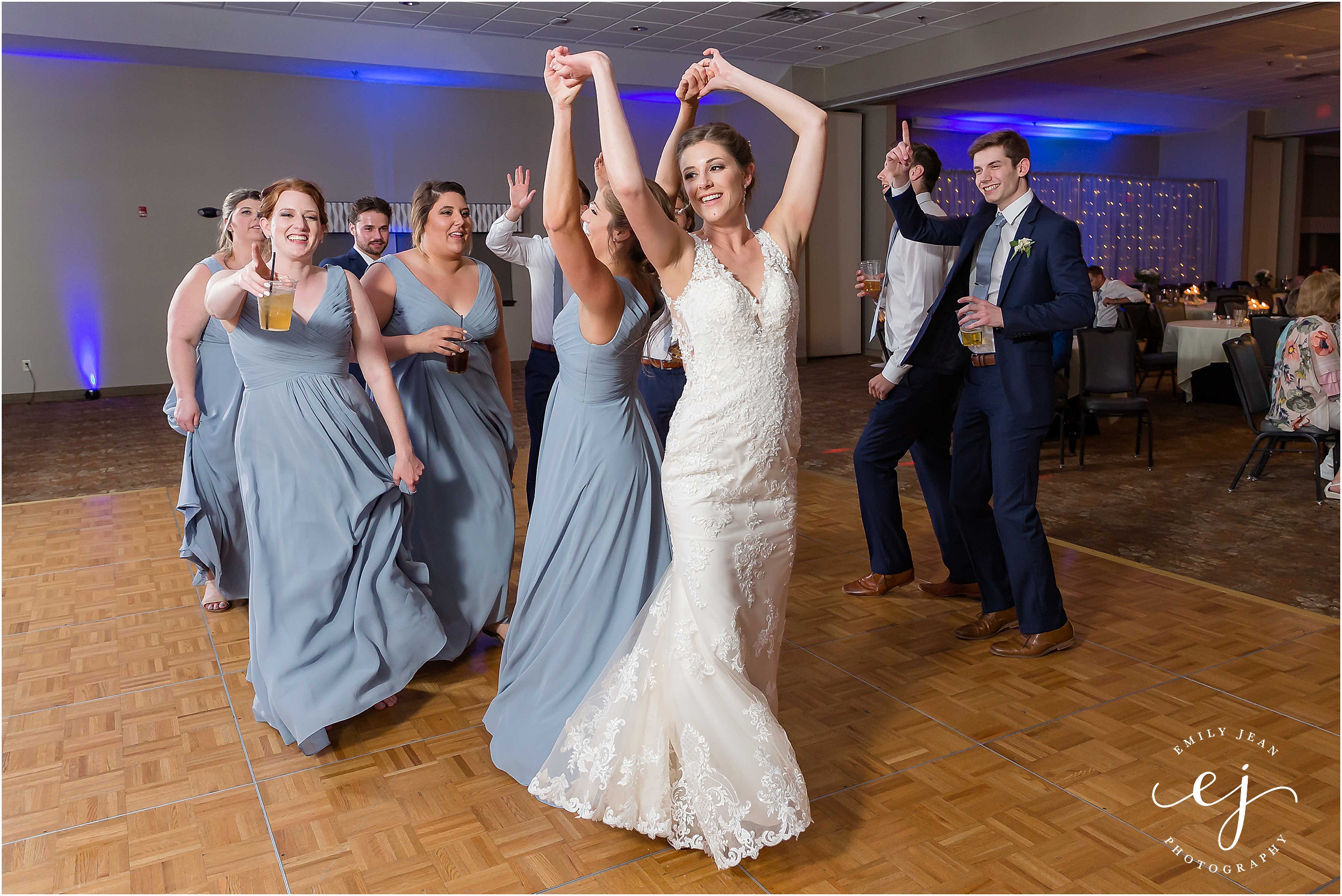 bride and bridesmaids dancing on ballroom floor