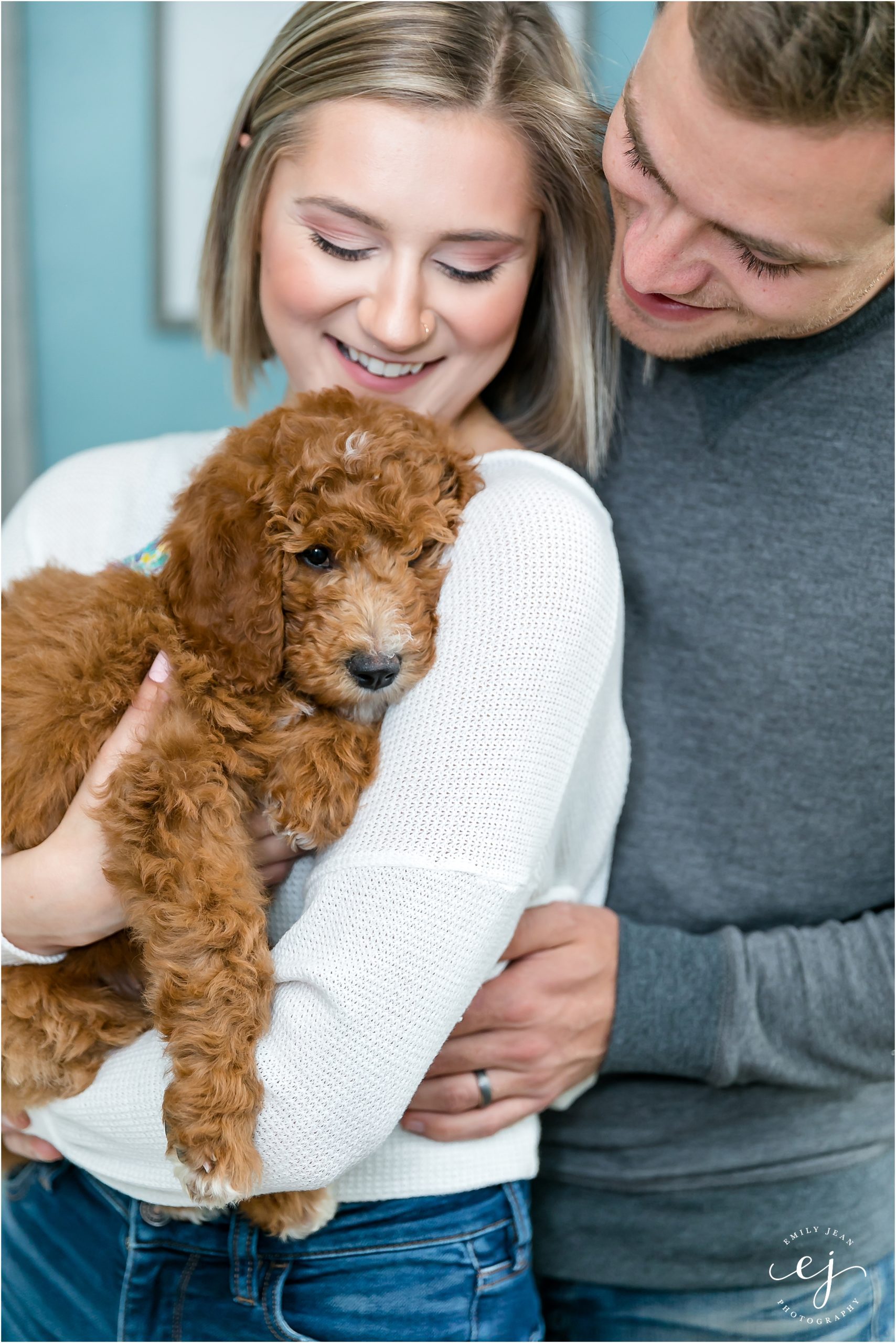 young couple snuggling new golden doodle puppy la crosse wisconsin