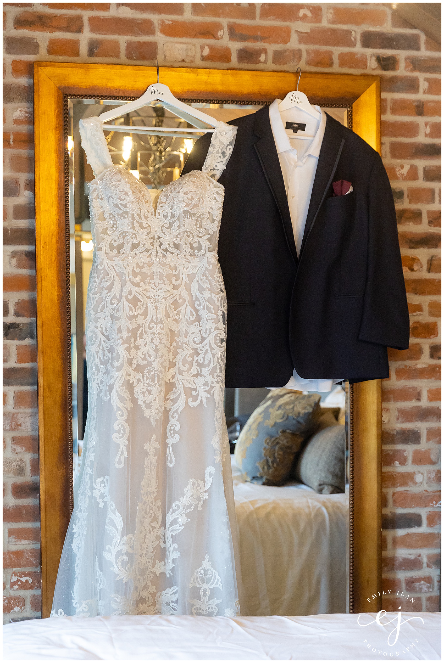 bridal gown and grooms suit hanging on the mirror in charmant hotel